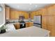 Corner view of the kitchen with quartz countertop and stainless-steel appliances at 9864 S Garland Ct, Littleton, CO 80127