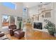 Bright and airy living room with high ceilings, large windows, hardwood floors, and a staircase at 9864 S Garland Ct, Littleton, CO 80127