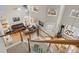 View from the staircase looking into the living room featuring hardwood floors and a ceiling fan at 9864 S Garland Ct, Littleton, CO 80127