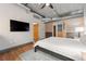 Bedroom with a large TV and sliding barn doors at 1401 Wewatta St # 204, Denver, CO 80202