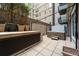 Relaxing hot tub on private patio with surrounding greenery at 1401 Wewatta St # 204, Denver, CO 80202