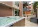 Private hot tub on patio with brick building backdrop at 1401 Wewatta St # 204, Denver, CO 80202