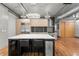 Modern kitchen with island, stainless steel appliances, and light wood cabinets at 1401 Wewatta St # 204, Denver, CO 80202