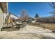 Exterior view of backyard featuring shed, patio with dining set and fenced yard at 114 Walnut Dr, Frederick, CO 80530