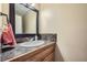 Powder room features a modern vanity with granite counters and stylish mosaic tile backsplash at 114 Walnut Dr, Frederick, CO 80530