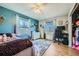 Bedroom featuring hardwood floors, multiple windows, and lots of natural light at 114 Walnut Dr, Frederick, CO 80530