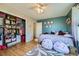 Bedroom featuring hardwood floors, a ceiling fan and a large, organized closet at 114 Walnut Dr, Frederick, CO 80530