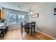 Bright dining area features a modern table set, hardwood floors, and natural light, creating a welcoming space for meals at 114 Walnut Dr, Frederick, CO 80530