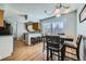 The dining area offers hardwood floors, a modern table set, and seamlessly connects to a kitchen with an island at 114 Walnut Dr, Frederick, CO 80530