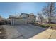 Charming two-story home featuring an attached garage, large driveway and a well-manicured front yard at 114 Walnut Dr, Frederick, CO 80530