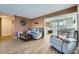 Cozy living room features comfortable seating, stylish decor, and an open layout, seamlessly connecting to the dining area at 114 Walnut Dr, Frederick, CO 80530