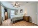 Main bedroom features hardwood floors, a ceiling fan and a large window at 114 Walnut Dr, Frederick, CO 80530