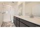 Modern bathroom features dual sinks, granite countertops, and a sleek glass-enclosed shower at 1954 S Haleyville Way, Aurora, CO 80018