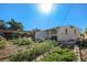 The backyard features lush garden beds, a small storage building, and a private fence; ready for outdoor enjoyment at 481 Cragmore St, Denver, CO 80221