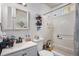 Bright bathroom featuring a vanity with sink, a mirrored cabinet, and a shower-tub combination at 481 Cragmore St, Denver, CO 80221