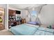 Bedroom featuring large window, built-in shelving, and a desk at 481 Cragmore St, Denver, CO 80221