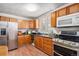 Kitchen with stainless steel appliances, wood cabinets and sink with large window at 481 Cragmore St, Denver, CO 80221