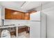 Functional kitchen featuring warm wood cabinets, tiled countertops, and a full-sized refrigerator at 481 Cragmore St, Denver, CO 80221