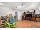 A cozy room with wood-look flooring, a vintage entertainment center, and a small dining set creates a homely atmosphere at 481 Cragmore St, Denver, CO 80221