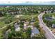 Aerial perspective shows homes near walking trails and street, surrounded by lush, mature trees at 3916 S Telluride Ct, Aurora, CO 80013