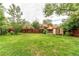 Spacious backyard with mature trees, shed, and wooden fence at 3916 S Telluride Ct, Aurora, CO 80013