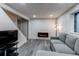 Finished basement with stylish gray flooring and a wall-mounted electric fireplace at 3916 S Telluride Ct, Aurora, CO 80013