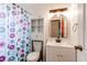 Full bath features a single sink vanity and a colorful shower curtain at 3916 S Telluride Ct, Aurora, CO 80013