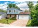 Charming two-story home featuring a brick-and-siding facade, attached garage with a basketball hoop, and a tidy front lawn at 3916 S Telluride Ct, Aurora, CO 80013