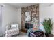 Cozy seating area featuring a stone fireplace and plush chair at 3916 S Telluride Ct, Aurora, CO 80013