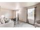 Bright living room with neutral colors, large windows, and a view to the neighborhood at 3916 S Telluride Ct, Aurora, CO 80013