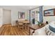 Well-lit dining room features a rustic wood table, decor, and patio access at 17214 W 94Th Ave, Arvada, CO 80007