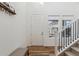 Bright entryway features wood floors, coat rack, front door, and stairwell at 17214 W 94Th Ave, Arvada, CO 80007