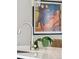 Modern kitchen counter features sleek fixtures, an artistic painting, and decor at 17214 W 94Th Ave, Arvada, CO 80007