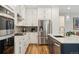Bright kitchen with stainless steel appliances and white cabinets at 17214 W 94Th Ave, Arvada, CO 80007