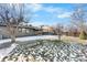 Large backyard with gravel and grass areas, partially covered by snow at 9163 W 75Th Cir, Arvada, CO 80005