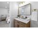 Contemporary bathroom with wood vanity and gold accents at 9163 W 75Th Cir, Arvada, CO 80005