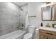 Clean bathroom with grey tile and gold fixtures at 9163 W 75Th Cir, Arvada, CO 80005