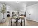 Modern dining area with glass table and four cushioned chairs at 9163 W 75Th Cir, Arvada, CO 80005