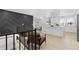 Open concept kitchen with island and modern gray accent wall at 9163 W 75Th Cir, Arvada, CO 80005