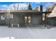 Covered patio with double doors leading to backyard at 9163 W 75Th Cir, Arvada, CO 80005