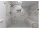 Large walk-in shower with built-in seat and modern fixtures at 9163 W 75Th Cir, Arvada, CO 80005