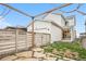 Home's fenced backyard featuring a pergola, grass, and stone pavers at 8028 Williams Fork Ave, Littleton, CO 80125