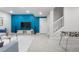 Finished basement featuring blue accent wall, foosball table, and comfortable seating at 8028 Williams Fork Ave, Littleton, CO 80125