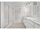 Bright bathroom featuring double sinks, a glass shower, and tile flooring at 8028 Williams Fork Ave, Littleton, CO 80125
