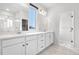 Elegant bathroom with double vanity, sleek fixtures, and a glass-enclosed shower at 8028 Williams Fork Ave, Littleton, CO 80125