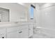 Bright bathroom featuring white cabinets, a shower-tub combo, and a large vanity at 8028 Williams Fork Ave, Littleton, CO 80125