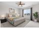 Serene bedroom with a large window, ceiling fan, and comfortable furnishings at 8028 Williams Fork Ave, Littleton, CO 80125