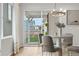 Bright dining area with a modern chandelier, seating for four, and sliding glass doors to the outdoor patio at 8028 Williams Fork Ave, Littleton, CO 80125