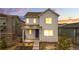 Charming two-story home featuring modern design, landscaped yard, and a welcoming front porch with a blue front door at 8028 Williams Fork Ave, Littleton, CO 80125