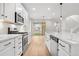 Bright and open kitchen with stainless steel appliances, a large island with a sink, and a view of the backyard at 8028 Williams Fork Ave, Littleton, CO 80125